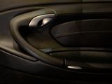 a close up of a car door handle and steering wheel