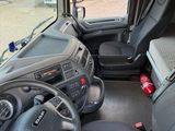 a view of the inside of a truck from the driver ' s seat