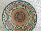 a green and brown plate with a star of david on it