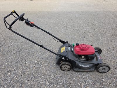 an image of a lawn mower sitting on the ground
