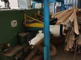 a machine that is cutting wood in a factory