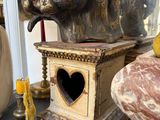 a statue of an elephant with a heart in its trunk