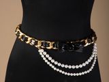 a close up of a mannequin belt with pearls on it