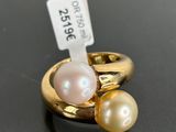a close up of a ring with two pearls and a price tag