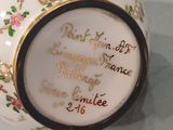 a white vase with a gold trim and a quote on it