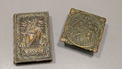 pair of antique brass bookends depicting a man and a woman