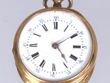 une montre de poche en or avec des chiffres romains sur le cadran