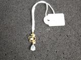 a close up of a necklace with a tag attached to it