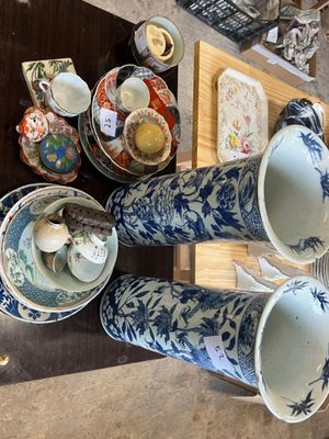 a table with a bunch of vases and plates on it