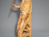 statue of a woman with a long hair holding a stick