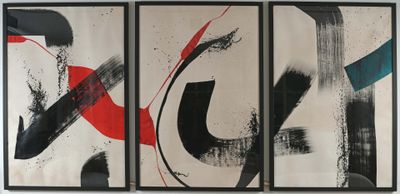 three abstract paintings hanging on a wall in a living room