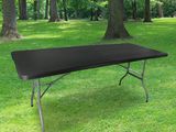 a black table in the middle of a grassy field