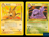two pokemon cards with a picture of a cat and a dog on them