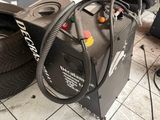 a tire dryer sitting on the floor next to a pile of tires