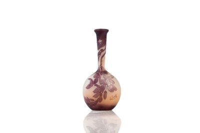 purple and white vase sitting on top of a white surface