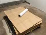 a roll of paper sitting on a pallet in a room
