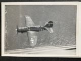 a black and white photo of a plane flying in the sky