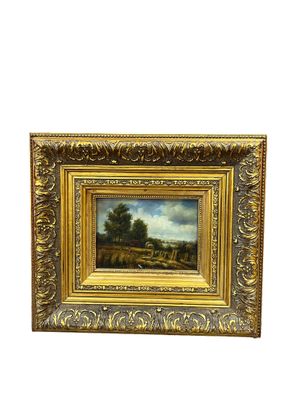 un tableau représentant un paysage avec une rivière et des arbres, dans un cadre doré