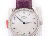 a close up of a wrist watch with a purple strap