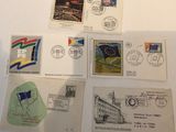 several different postcards and envelopes are on a table