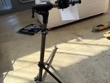 a camera on a tripod next to a couch in a room