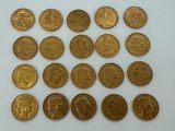 a bunch of gold coins sitting on top of a white surface