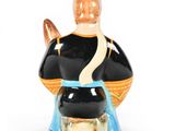 an image of a ceramic figurine of a man with a hat on his head