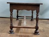 a small table with a wooden top on a hard wood floor