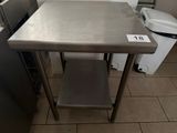 a stainless steel table in the kitchen with a number on it
