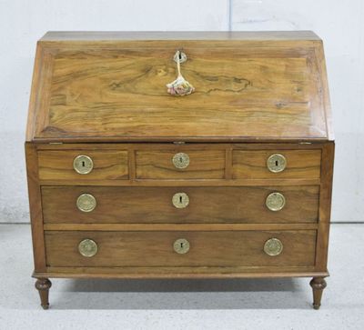 an old wooden desk with drawers and brass hardware on it