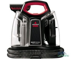 un gros plan d'un aspirateur noir et rouge sur fond blanc