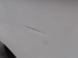 a close up of a car ' s front bumper with a hole in it