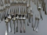 a lot of spoons and silverware on the table