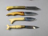 several knives are lined up in a row on a table