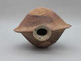 a brown vase with a hole in it on a white surface