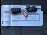 two car keys and a keychain on a piece of paper