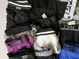 a pile of assorted underwear on a white surface
