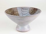 a white bowl with a flower design on it