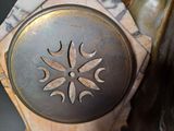 a close up of a clock with a decorative design on it