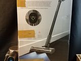 the box is open on a table with a vacuum on it