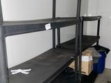 a black shelf with boxes on it in a room