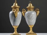 une paire de vases anciens posés sur une table blanche