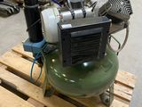 an air compressor sitting on a pallet in a warehouse