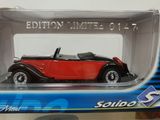 a red and black model of a car in a box