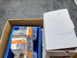 a box of batteries sitting on the floor next to a box of batteries