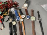 a lot of watches and bracelets on the table