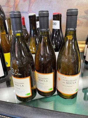 several bottles of wine are lined up on a counter