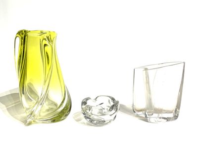 a yellow vase and two glasses on a white surface