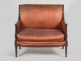 an image of a brown leather chair with a wooden frame