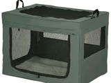 une image représentant une petite cage de transport verte pour chien, avec un couvercle noir